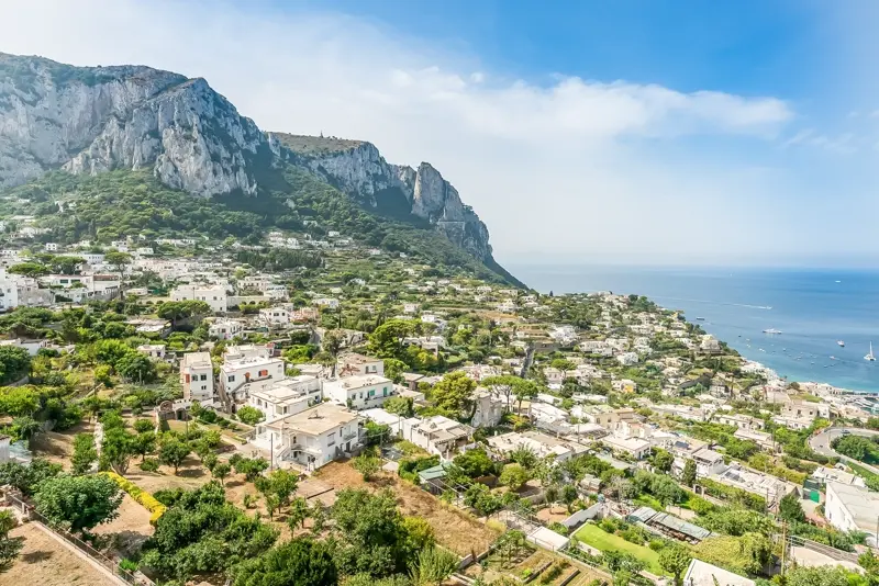 Panorama over Capri's whitewashed town and cliffs toward the sea