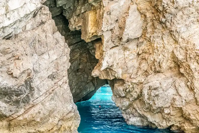 A narrow turquoise channel between Capri's limestone sea cliffs